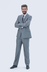 Full length of a young caucasian businessman with arms folded