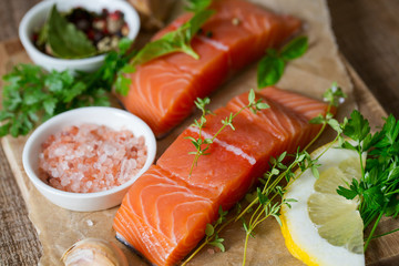 fresh salmon fillet on brown wooden surface