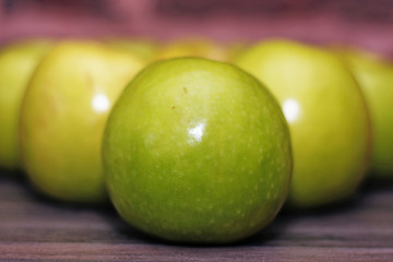green apples on a wooden table