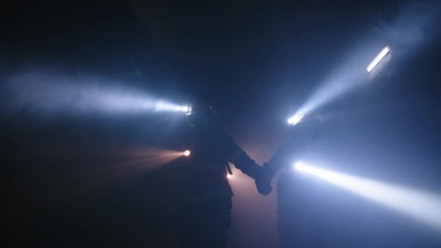Firefighters during a rescue operation in a dark tunnel filled with smoke