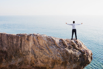 Freedom successful businessman over a high mountain