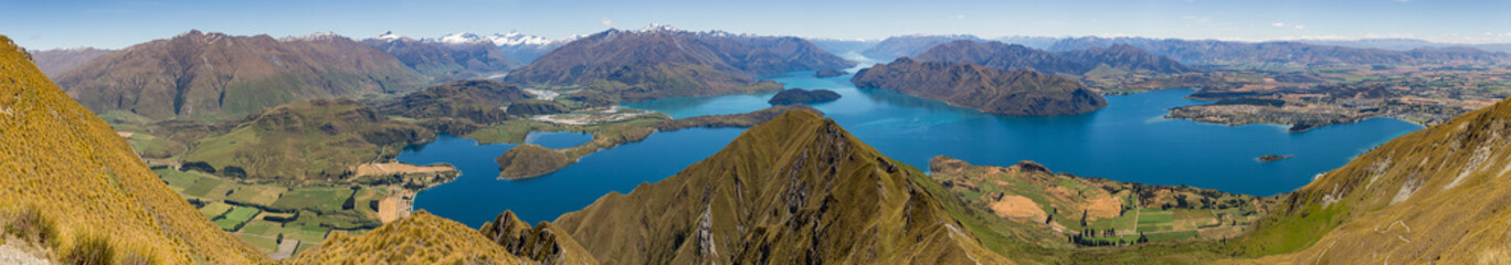 Naklejka na ściany i meble Panoramic view of Wanaka and the surrounding lake and mountain range, from the Roy's Peak track in New Zealand