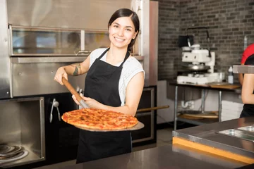 Wall murals Pizzeria Smiling chef holding big shovel with pizza