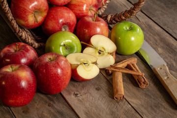 Apples red and green on rustic wooden table in basket 