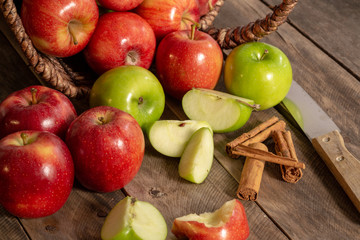 Apples red and green on rustic wooden table in basket 