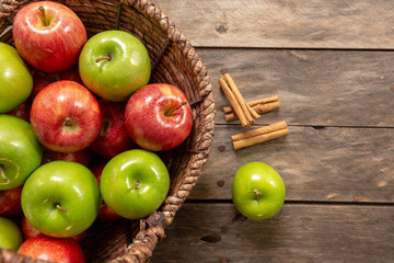 Apples red and green on rustic wooden table in basket 