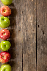 Apples red and green on rustic wooden table in basket 