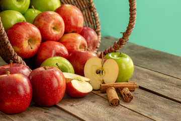 Apples red and green on rustic wooden table in basket 