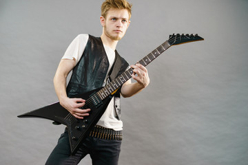 Young man playing electric guitar