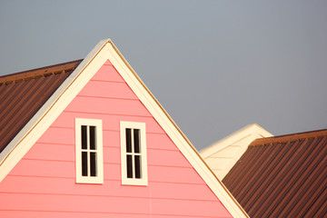 gable roof with white windows on wooden house