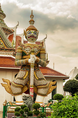 Statues at Wat Arun monumental Buddhist temple in Bangkok, Thailand.