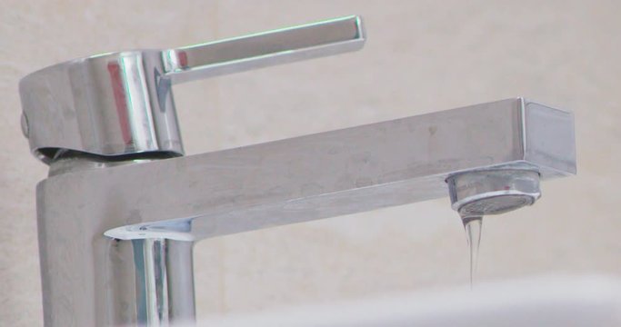 water droplets on tap in batroom leaking
