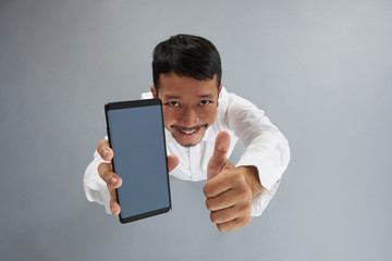 Asian man hold smartphone and show thumb up