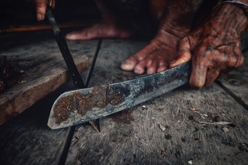 Muara Siberut, Mentawai Islands / Indonesia - Aug 15 2017: Tribal man sharpening his arrow for...