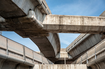 large and imposing concrete overpasses against a blue sky, Bangkok Thailand