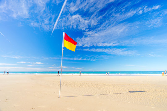 Surf life saving flag on the beach with blue water - Gold Coast, Queensland, Australia