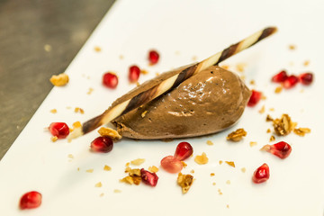 piece of brown mousse au chocolate sweet dessert and decoration on a white plate background