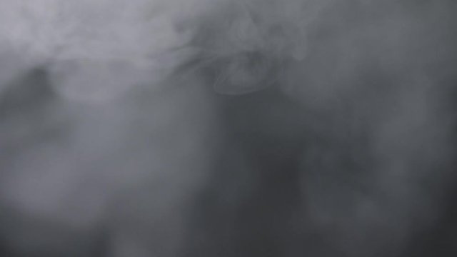 White smoke in front of black background