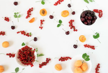 Summer yummy fruits, berry background, food colors pattern  from apricots, cherries, red currant  on a white background. Flat lay. Top view. Copy space