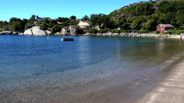 Norwegian sandy beach in Kjerringvik with man swimming