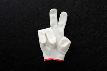 white glove with gesture of TWO on black background