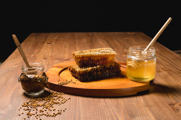 Jar of honey with honeycomb on wooden table. delicious honey honey