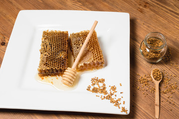 Fototapeta na wymiar Jar of honey with honeycomb on wooden table. delicious honey honey