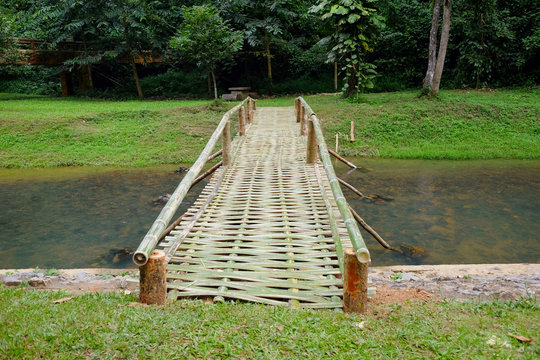 Bamboo bridge hanging bridge over the river in tropical forest at Thailand
