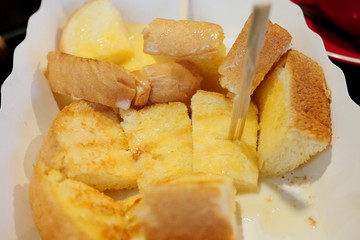 Garlic bread and herb bread slice in white plate.