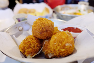 Fried Fish balls and tomato sauce in white plate on the table.