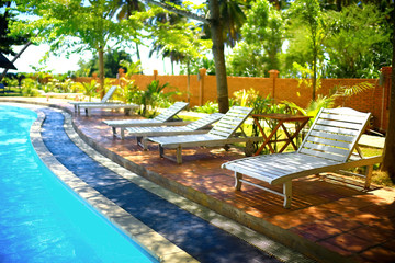 Swimming pool with sun loungers