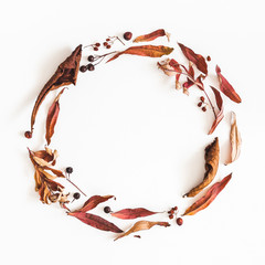 Autumn composition. Wreath made of autumn dried leaves on white background. Flat lay, top view, copy space