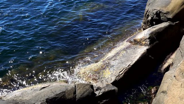 Rocks at north sea in Kjerringvik Norway with sunny weather and blue sky, close up to rocks,