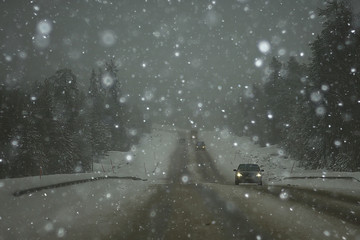 snow and fog on the winter road landscape / view of the seasonal weather a dangerous road, a winter lonely landscape