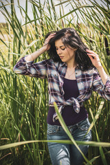 American woman style, plaid shirt and blue jeans. Simple and fashionable clothes. Concept of...