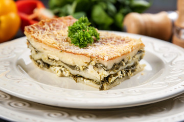 Lasagna with spinach on plate, close up