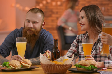 Friends with beer and snacks in sport bar