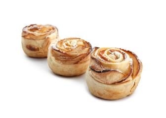 Tasty apple roses from puff pastry on white background