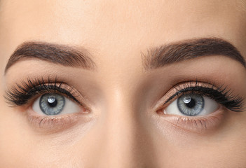 Young woman with beautiful eyebrows after correction, closeup