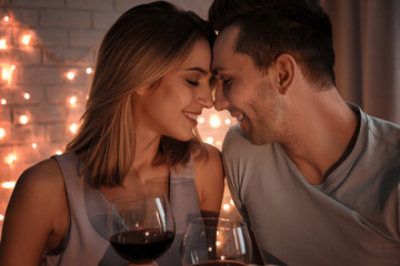 Young loving couple against blurred lights background