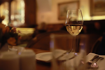 glass of white wine in the restaurant / white wine in the interior of the restaurant a table with glasses of wine, a romantic summer
