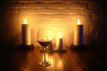 red wine glass serving / romantic dinner in the interior of the restaurant, a table served with a glass of grapes wine