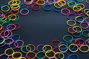 Information sharing concept, colorful rubber band on black background with copy space