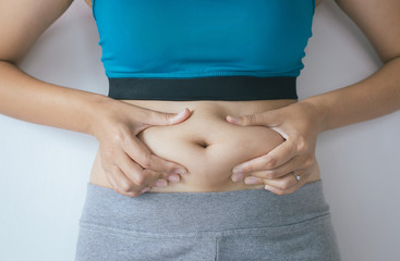 Woman with excess belly fat and overweight fatty bellys of female