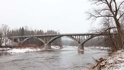 Gauja River.  A winter view of the Gauja River and road bridge crossing it.  The bridge is near Sigulda  Latvia and is a part of the Gauja National Park.
