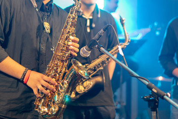 Obraz premium World Jazz festival. Saxophone, music instrument played by saxophonist player and band musicians on stage in fest.