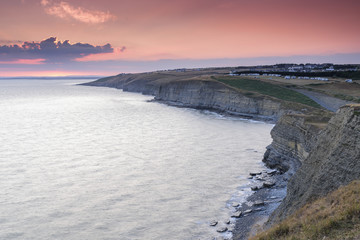 Fototapeta premium Spectacular sunset over Dunraven Bay, on the coast of South Wales, UK. Dunraven Bay is also know as Southerndown and featured as Bad Wolf Bay in the science fiction series of Dr Who