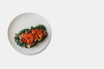 Delicious and nutritious toast or sandwich with bacon, spinach and tomato. Tasty food. Nearby place for text