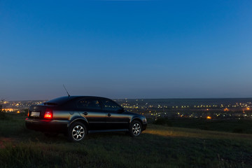 Obraz na płótnie Canvas Black car in the field at night