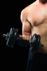 man doing an exercise with dumbbells to increase the muscles on a dark background